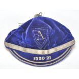 Sporting - An early 20th Century blue velvet cricket cap embroidered tassel, banding and dates.