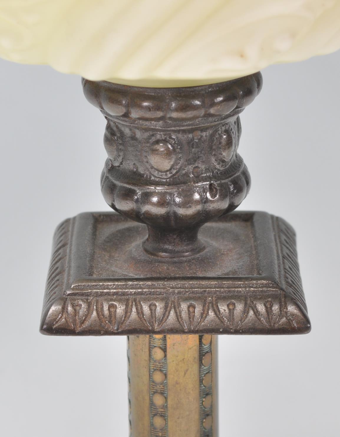 A 19th Century Victorian oil lamp of small proportions being raised on a square stepped base - Image 3 of 6