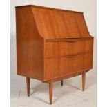 A good vintage retro 20th Century teak wood Danish influence bureau raised on tapering supports with