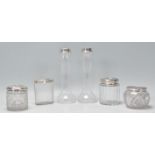 A mixed lot of silver and glass ladies dressing table items to include 2 silver vases having