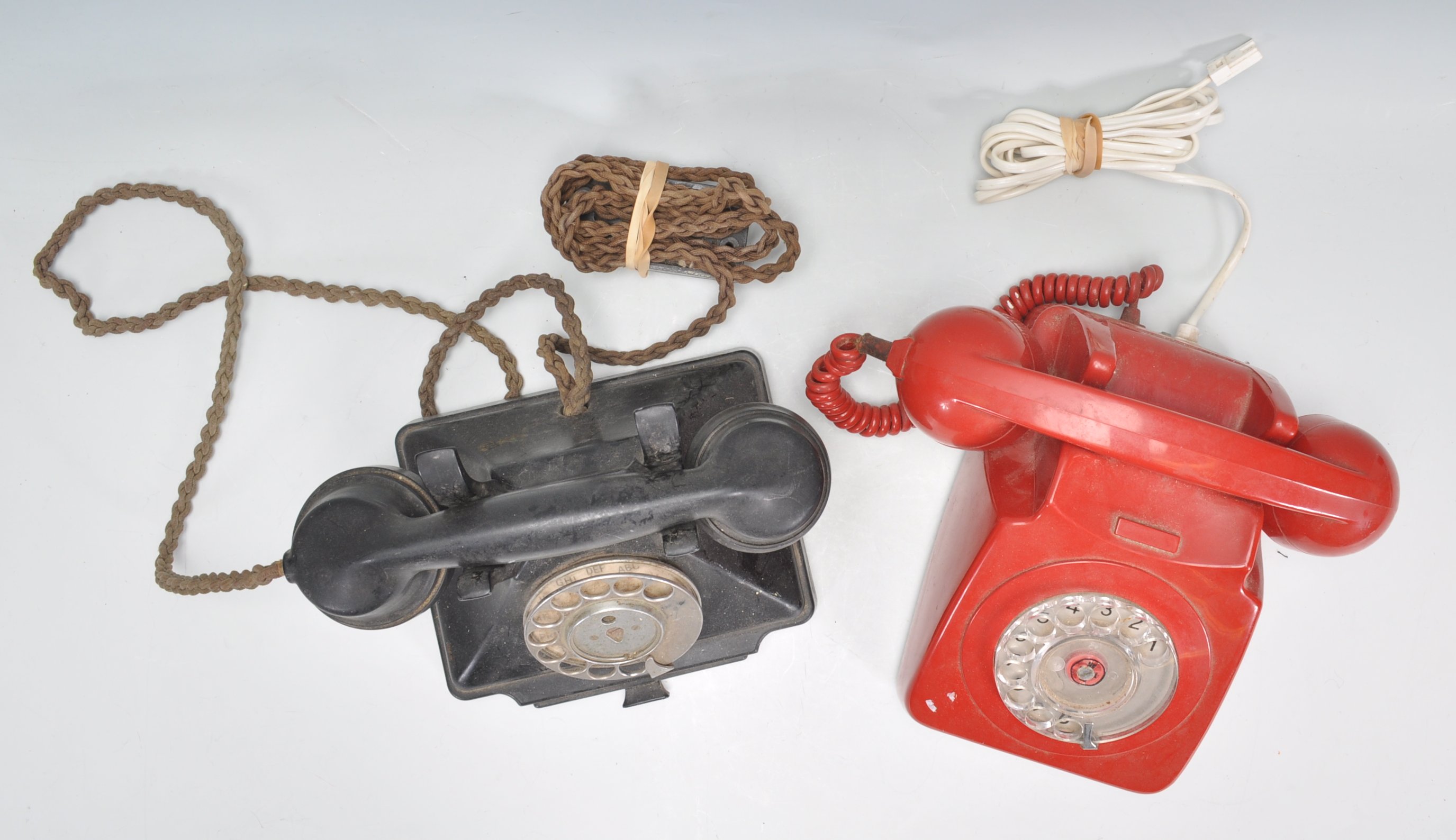 Two vintage 20th Century ring dial telephones to include a black bakelite example and a red - Image 4 of 4