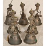 A collection of 7 20th century Industrial office factory pendant lamps of bell form with pierced