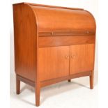 A mid century Danish influence teak wood cylinder bureau desk. Raised on square tapering legs with