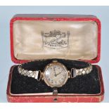 An Art Deco 9ct gold cased ladies wrist watch by Parsons Bristol. The silvered dial having Arabic