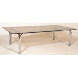 A 1970's Italian retro vintage large glass coffee table having a chromed tubular construction with