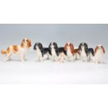 A collection of Beswick and similar porcelain glazed figurines of dogs to include Spaniels etc.