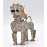 An unusual brass, turquoise and coral set temple dog - dog of fo. The unusual brass body inset
