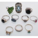 A group of ten silver rings to include a ring set with a round cut blue stone, a ring set with an