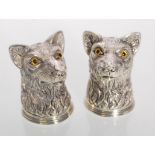 A pair of silver plated salt and pepper condiment shakers in the form of wolves set with glass eyes.