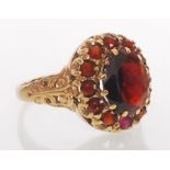 A hallmarked 9ct gold garnet cluster ring. Hallmarked London. Weight 4.2g. Size P.5.