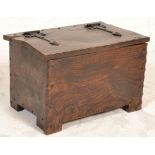 A 20th century antique revival elm coffer of small rustic proportions. Of rectangular form with