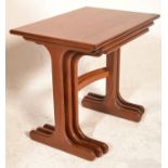 A 1970's G-Plan vintage retro teak wood nest of tables having shaped legs united by stretchers with