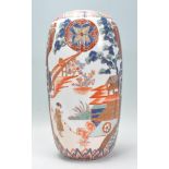 A 19th Century Japanese vase of ovoid form having hand painted and enameled decoration depicting a