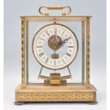 A Kieninger and Obergfell mantel clock having a brass case with glass panelled sides and an