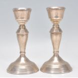 A pair of silver hallmarked candlesticks. Each with single sconces. Hallmarked for Birmingham 1977