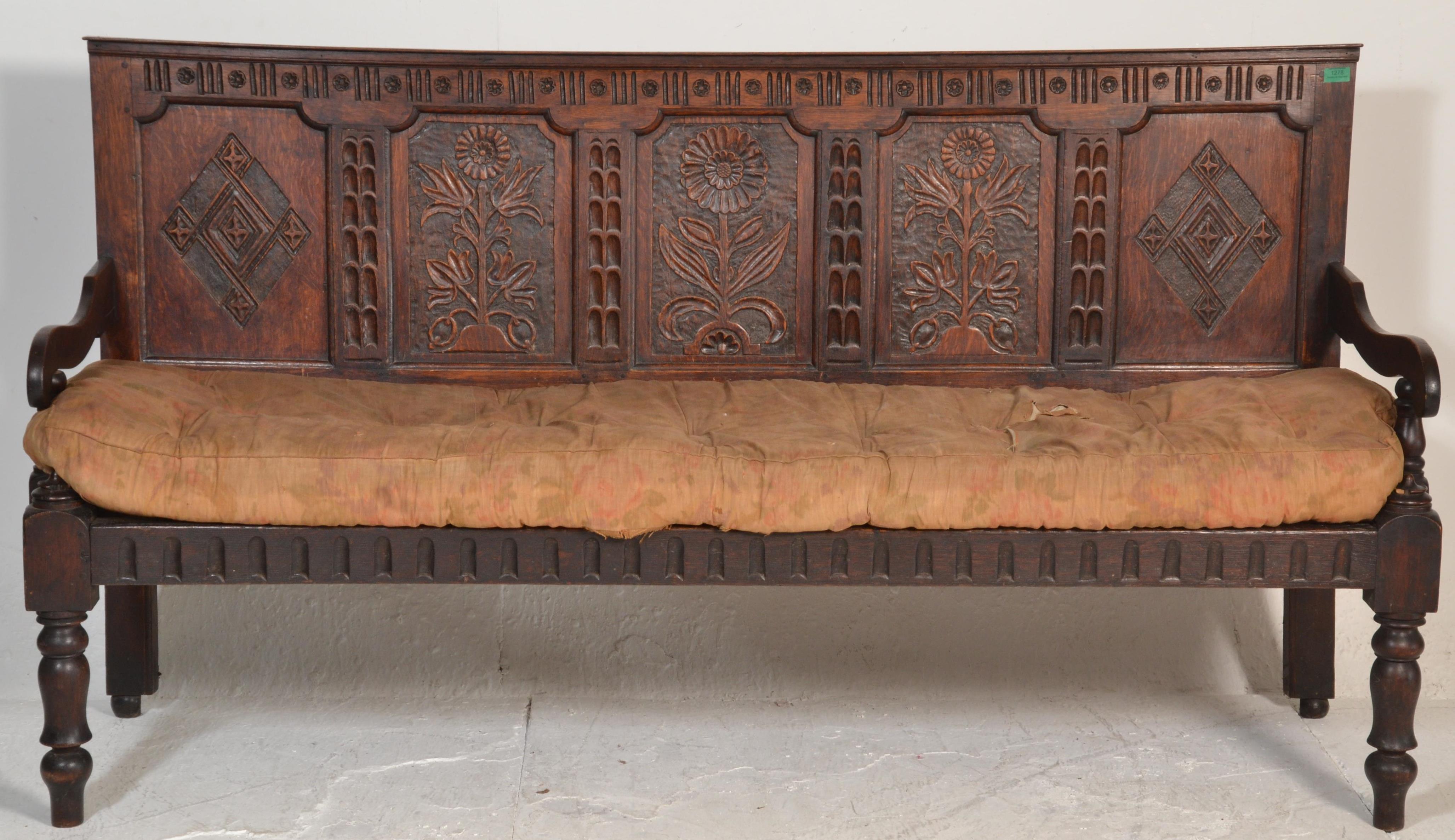 An 18th century large carved West country oak hall settle bench. Raised on turned legs with - Image 2 of 6