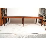 A large 20th century antique revival mahogany and leather library / boardroom table. Raised on