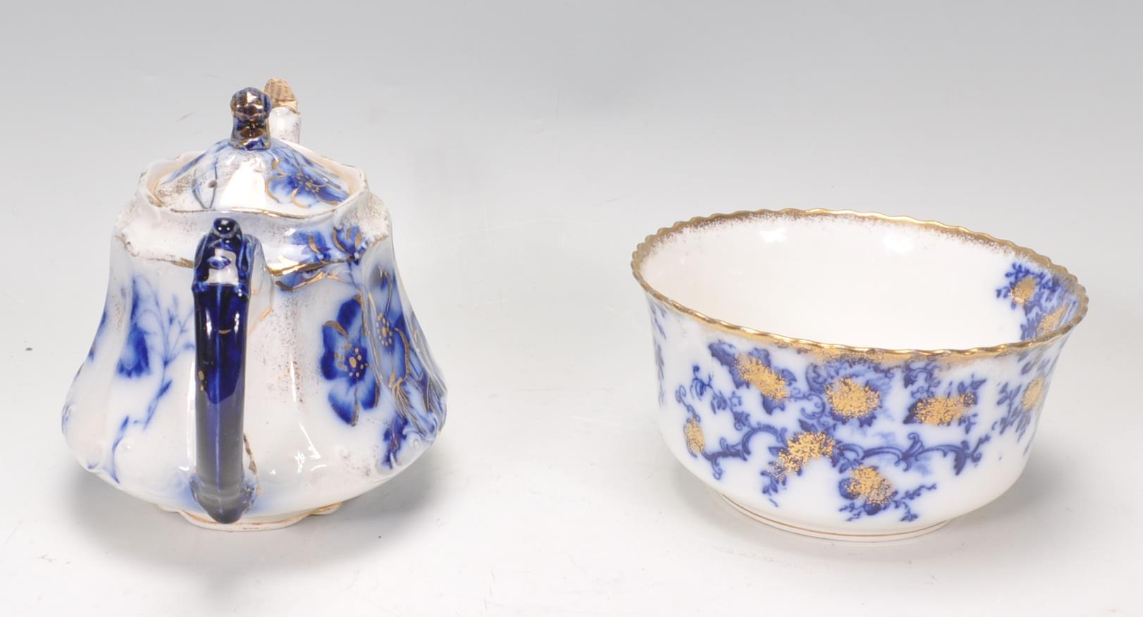 A collection of Victorian 19th century flow blue china to include dinner plates, teapot, cups, sugar - Image 5 of 8