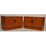 A pair of mid 20th century teak wood G-Plan low side cabinets. Raised on plinth bases with twin door