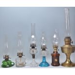 A collection of 19th Century Victorian oil lamps to include to include a green glass finger lamp,