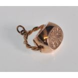 A good 9ct rose gold swivel fob having finely engraved floral and scroll decoration on a rope