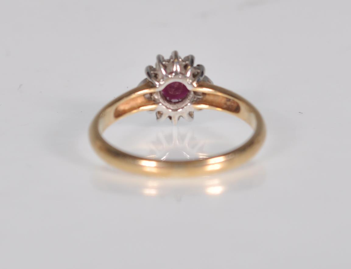 A hallmarked 9ct gold diamond and garnet flower head ring having a central faceted red stone with - Image 4 of 6