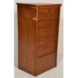 A mid century oak office factory filing cabinet of pedestal form. The upright body with tambour roll