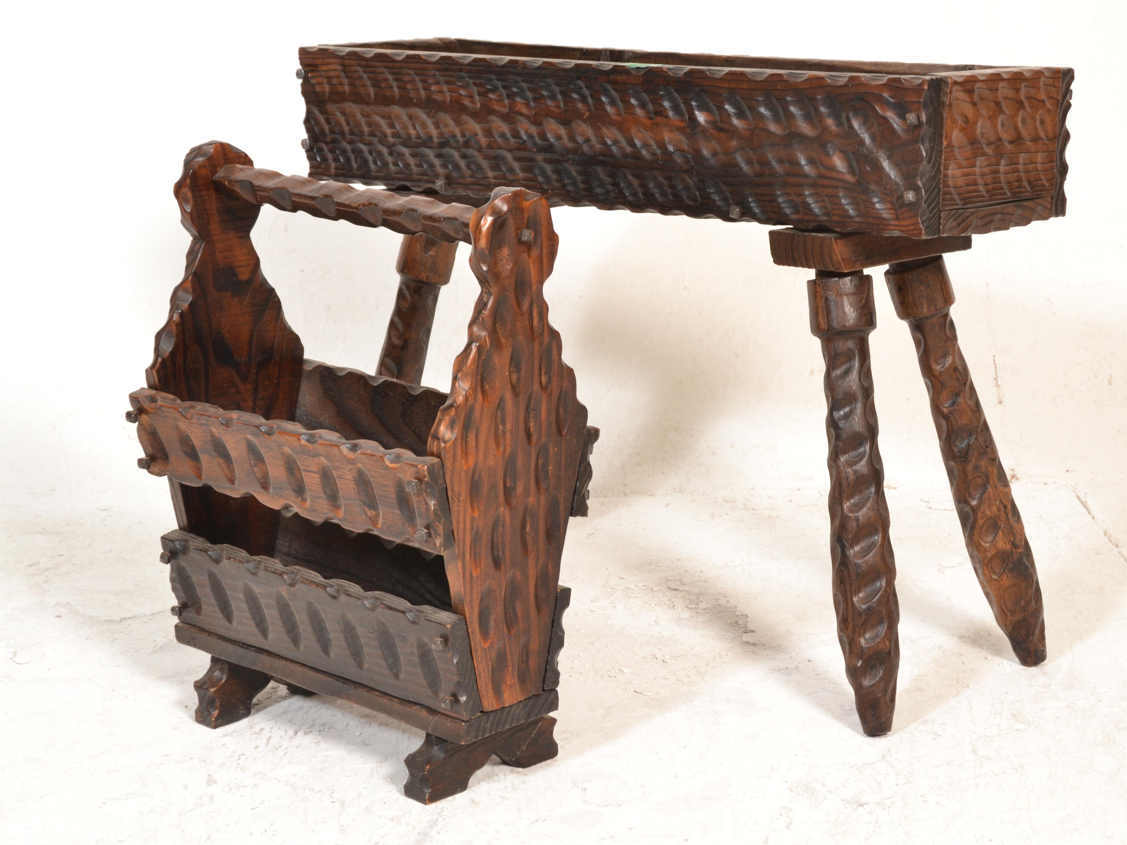 A rustic mid to early 20th century continental German black forest oak planter stand and magazine