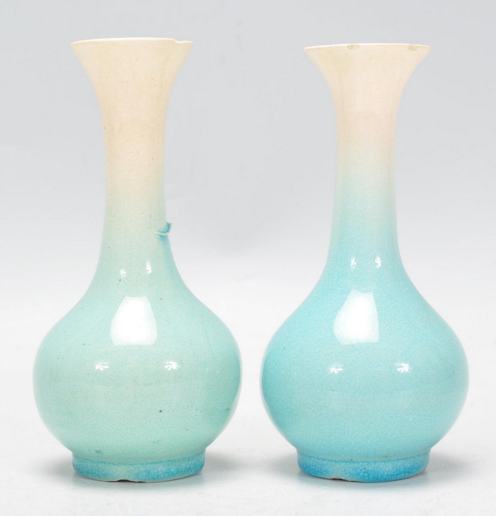 A pair of Japanese porcelain bottle vases vases with tapering cylindrical necks with flared necks