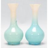 A pair of Japanese porcelain bottle vases vases with tapering cylindrical necks with flared necks