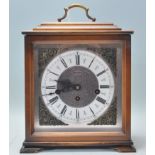A 20th century mahogany cased bracket clock by Hermle. Roman numeral chapter ring with faceted