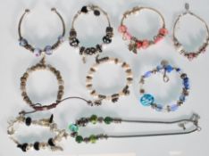 A group of silver white metal bracelets to include
