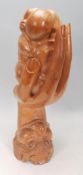 An unusual hardwood carved sculpture depicting fac