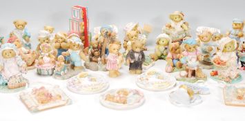 A large collection of Cherished Teddies of varying