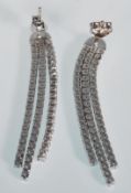 A pair of ladies silver drop earrings. Each earrin