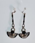 A pair of silver ladies drop earrings. In the styl