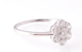 An 18ct white gold and  diamond cluster ring . The