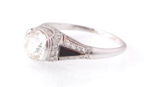 AN ART DECO PLATINUM ONYX AND OLD CUT DIAMOND RING