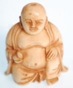 A late 19th Century Chinese carved ivory figure of the laughing Buddha in the seated lotus position.