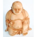 A late 19th Century Chinese carved ivory figure of the laughing Buddha in the seated lotus position.