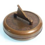 A brass cased Gilbert pocket sundial and compass, the round case opening to reveal the compass