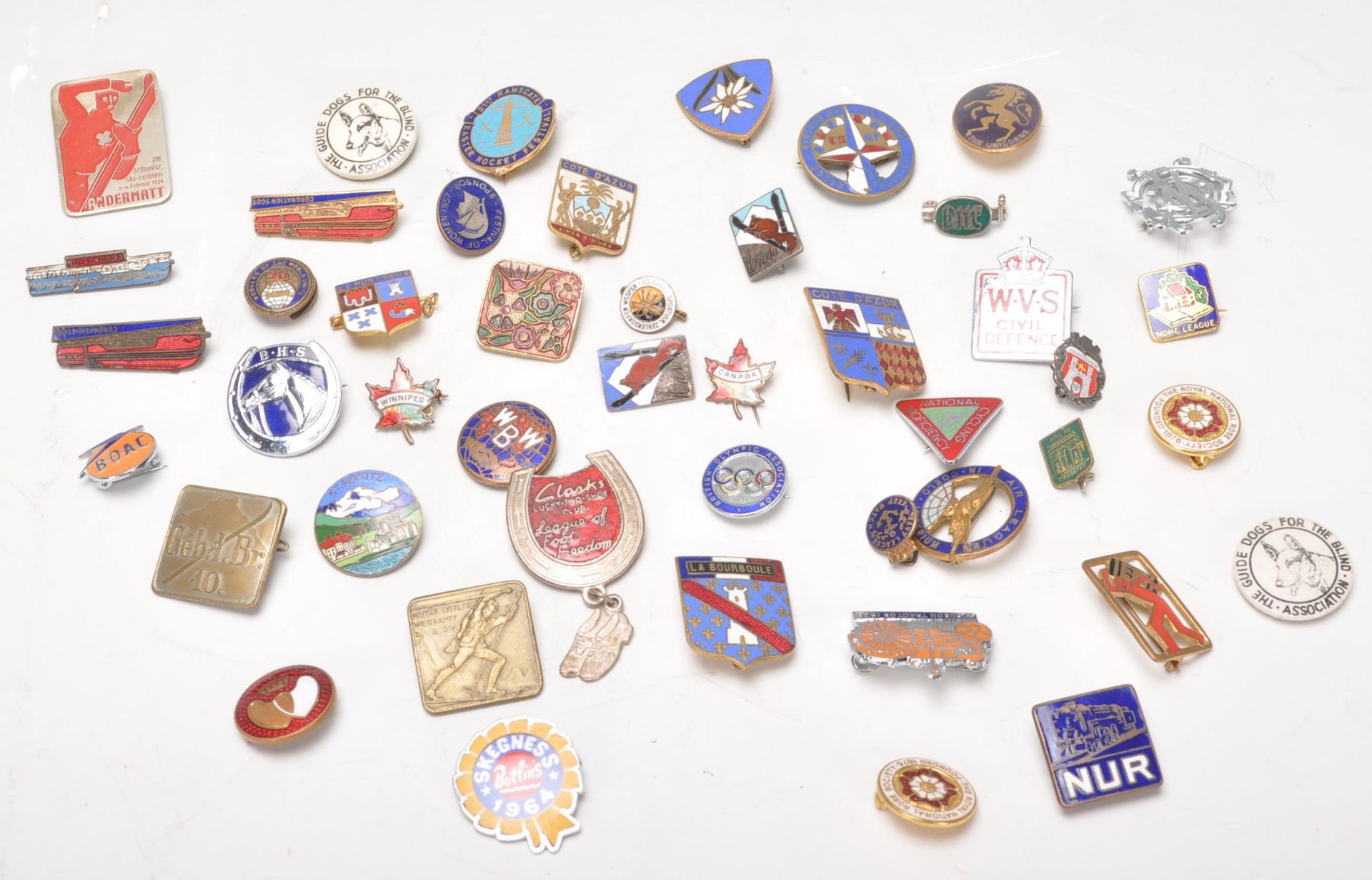 A collection of vintage pin badges dating from the early 20th Century. Multiple enameled examples to