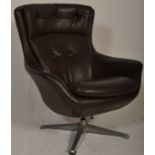 A retro mid century swivel egg chair  having a 4 point chrome swivel base with faux black leather