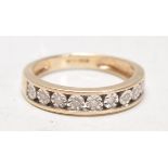 A 9ct gold hallmarked diamond channel set half eternity ring. The ring with 9 diamonds being