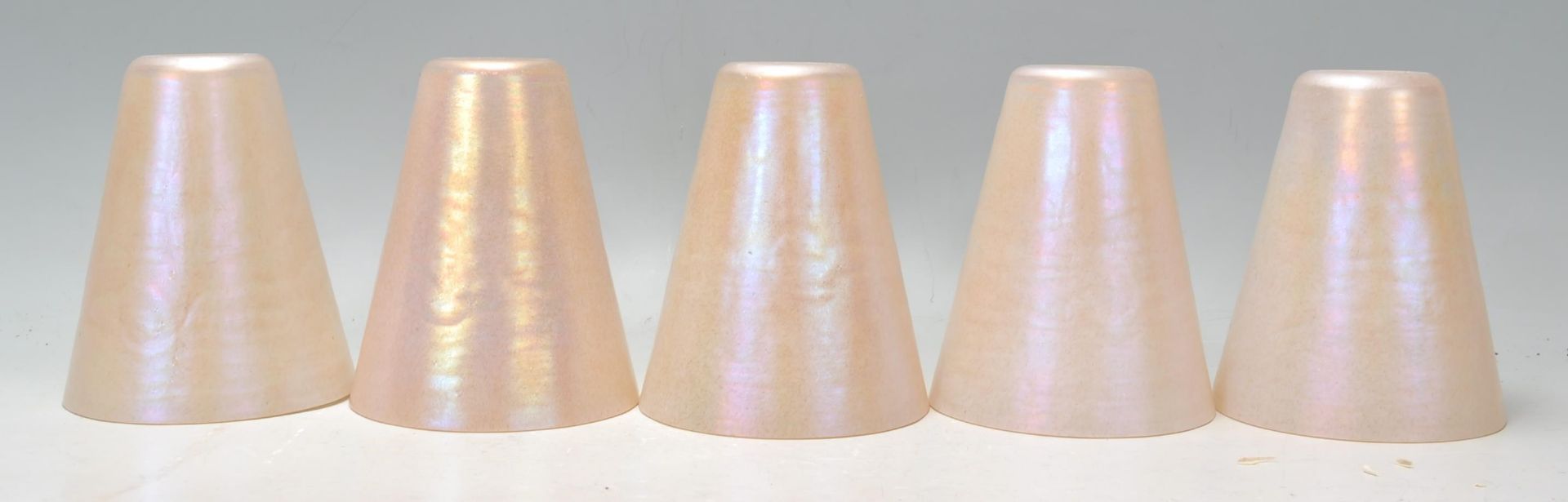 A collection of five 20th century retro conical lustre glass lamp shades. Each of conical form