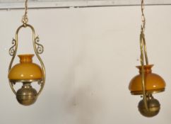 A contemporary pair of antique style large brass hanging lantern of oil lamp type with modern