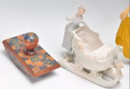 A collection of ceramics to include a Roskyl pottery Art Deco jug , two continental bisque figurines