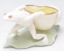A 19th century Victorian table salt in the form of a frog hauling a sea shell being raised onto a