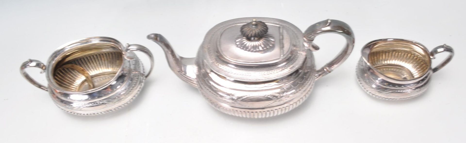 A late 19th century / early 20th century silver plate 3 tea service comprising teapot, sugar bowl - Image 10 of 11