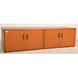 A vintage / retro 20th Century G Plan low teak wood sideboard credenza having two twin door cupboard